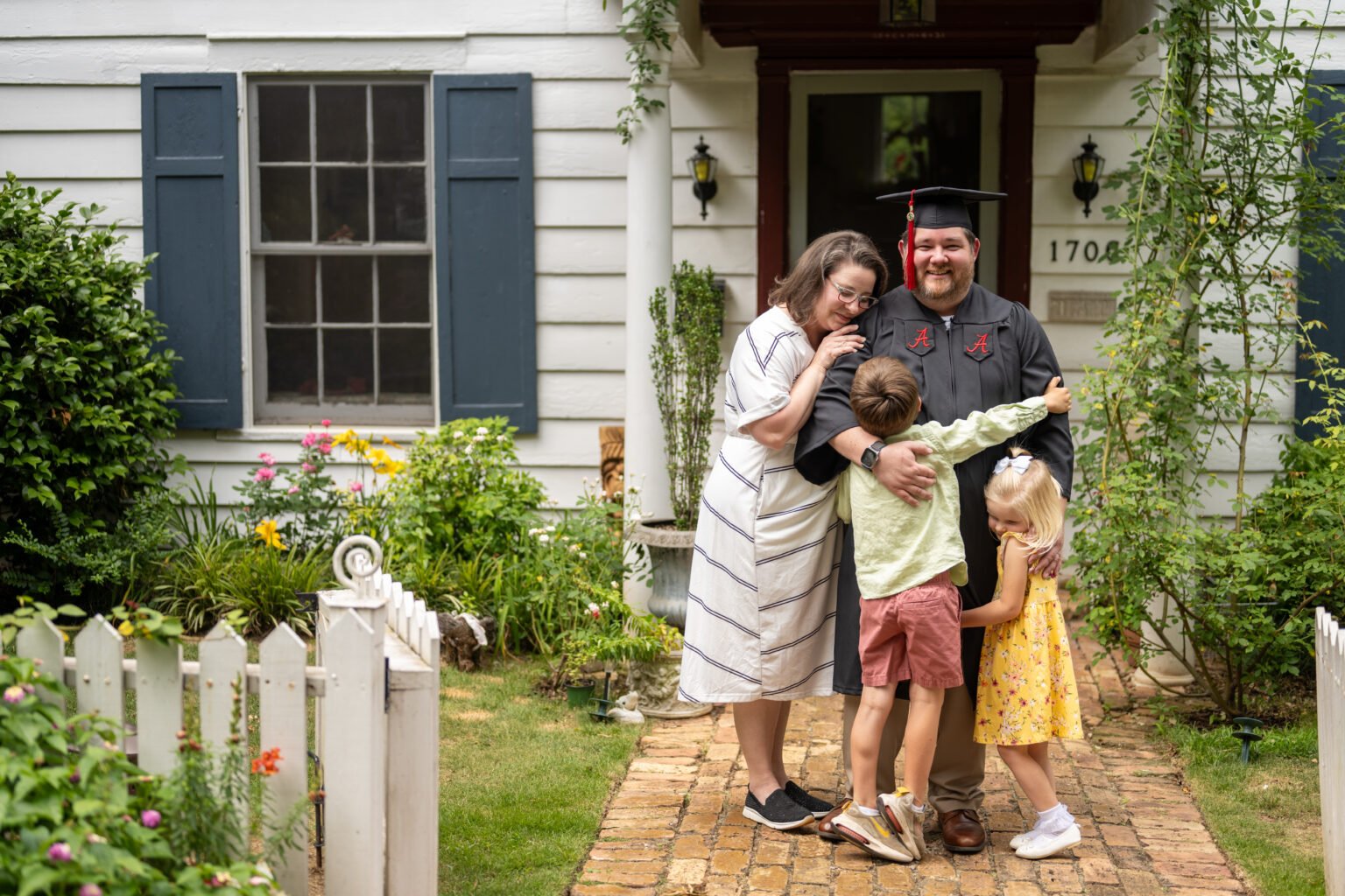 Family embrace with a UA Online graduate